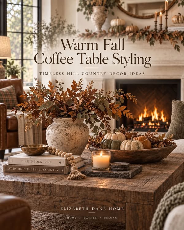 Elizabeth Dane Home post: Warm Fall Coffee Table Styling, a rustic coffee table with a stoneware vase of oak branches, a brass bowl, a candle, and a dough bowl of pumpkins by the fire